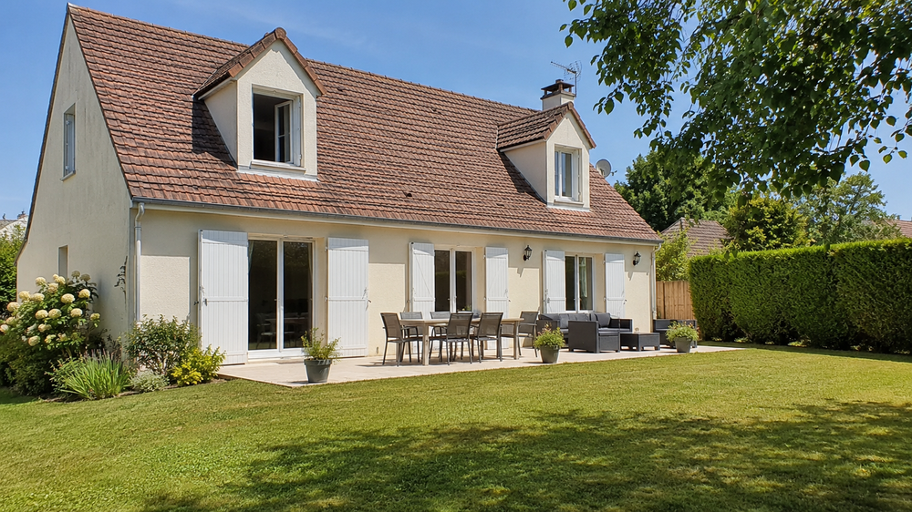 Une maison familiale à Nangis avec jardin entretenu, terrasse propre et lumière de fin d’été. Cette image illustre les actions à lancer dès la fin août pour préparer une vente immobilière en septembre dans les meilleures conditions.